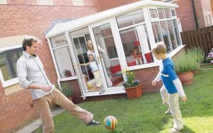 Lean to conservatory with family outside