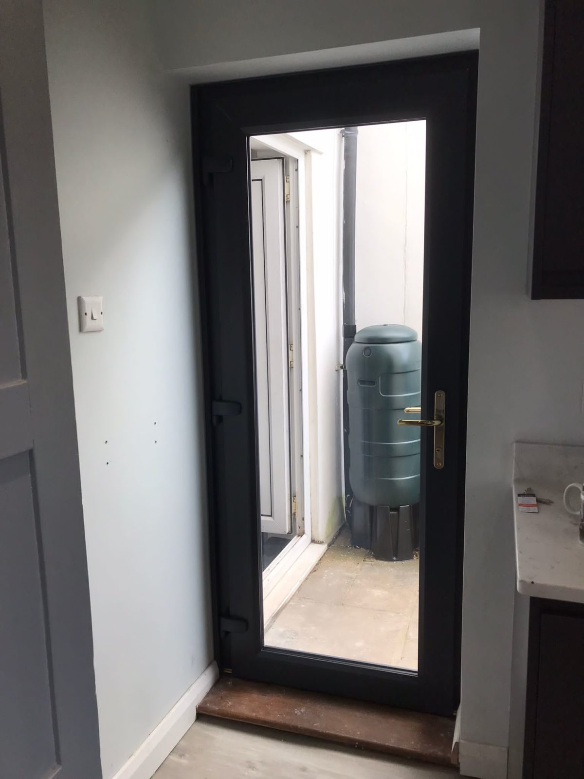 Composite Door With Modena Glass And A Grey UPVC Door
